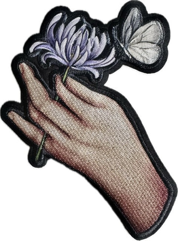 Brooch: Hand with blue flower